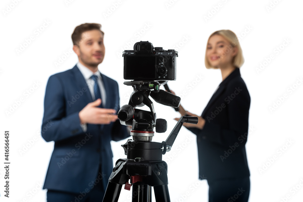 selective focus of digital camera near newscaster interviewing businessman on blurred background isolated on white selective focus of digital camera near newscaster interviewing businessman on blurred background isolated on white