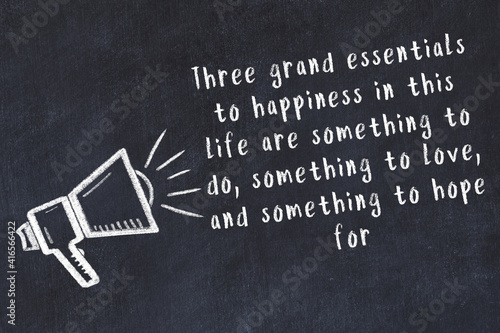 Konstfotografi Chalk sketch of loudspeaker on black desk and movitational quote