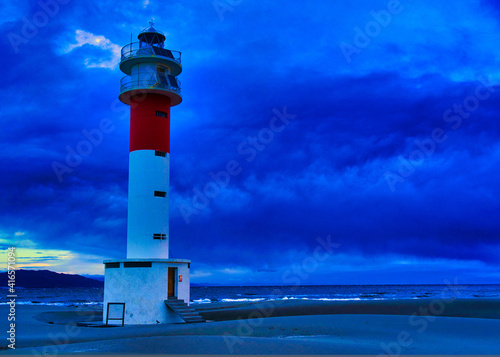 Fangar Lighthouse in Delta region of Ebre river cloudy day photo