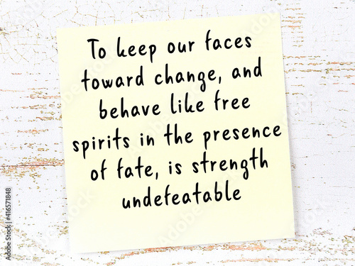 Yellow sticky note with handwritten motivational quote photo