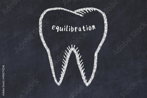 Chalk drawing of a tooth with medical term equilibration. Concept of learning stomatology photo
