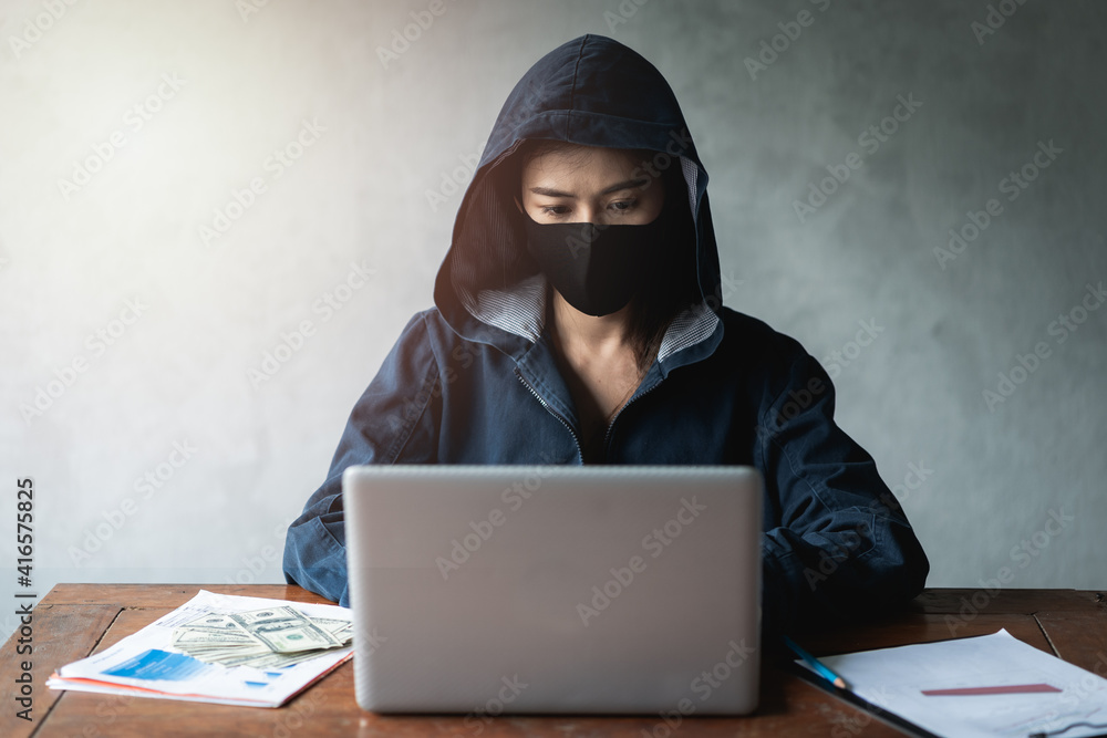 Dangerous Hooded Hacker using computers and infected virus ransomware to hacking a personal and financial data. Cybercrime, information technology, phishing mail. Dangerous Hooded Hacker using computers and infected virus ransomware to hacking a personal and financial data. Cybercrime, information technology, phishing mail.
