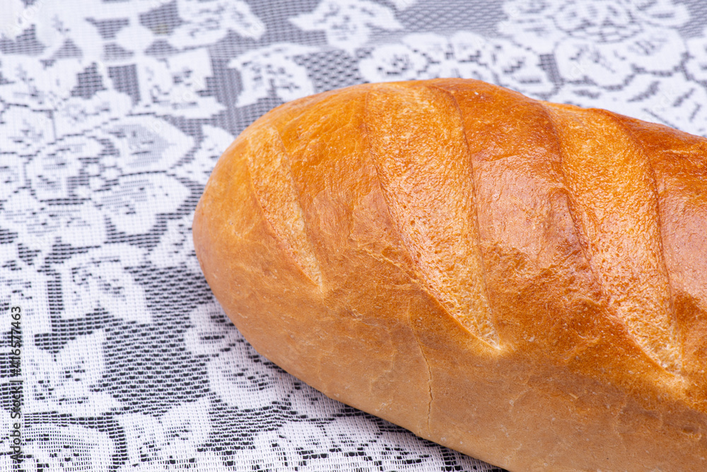 Loaf of bread on a white tablecloth