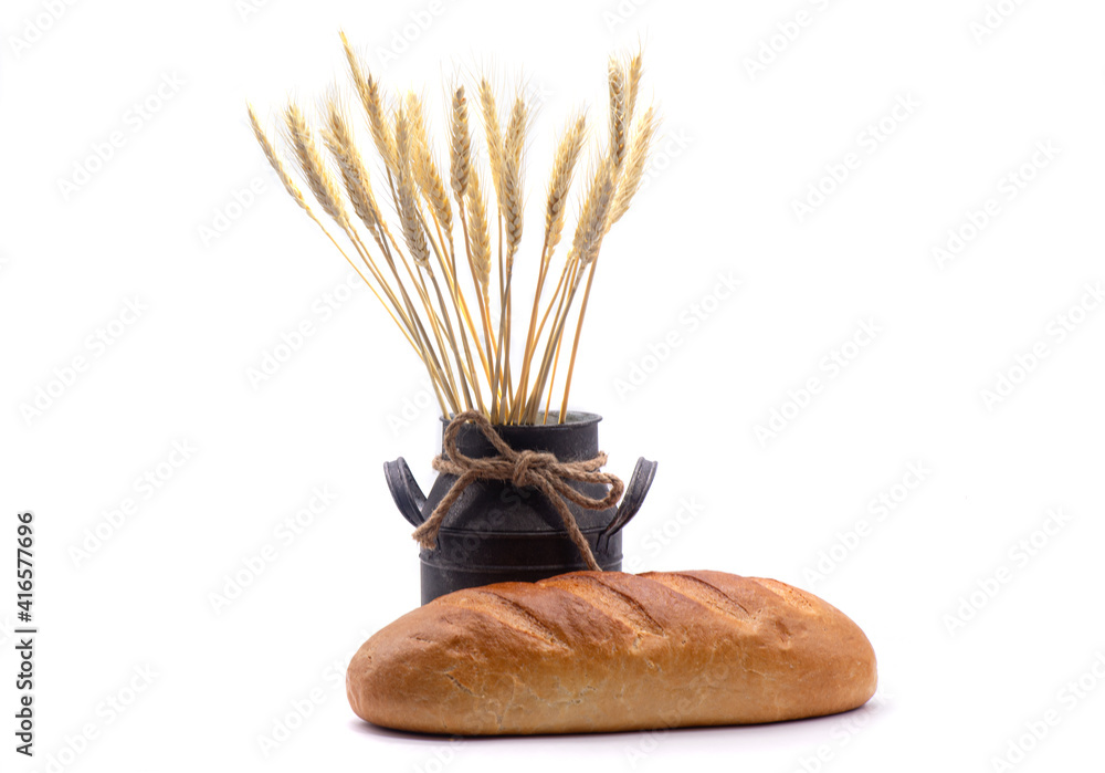 Composition of white bread, wheat, an old jug on white background
