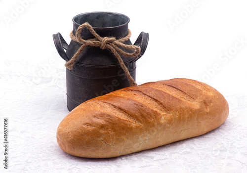 Obraz na płótnie Composition of white bread and old jug on a tablecloth on white background w salonie