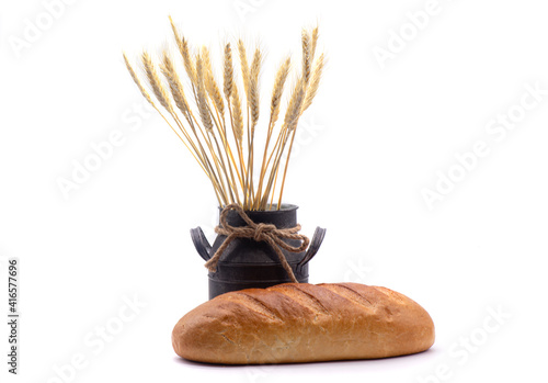 Obraz na płótnie Composition of white bread, wheat, an old jug on white background w salonie