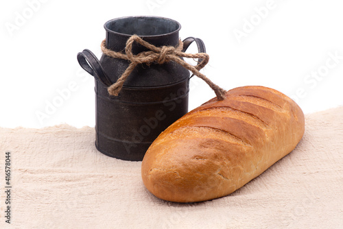 Obraz na płótnie Composition of white bread and old jug on a tablecloth on white background w salonie