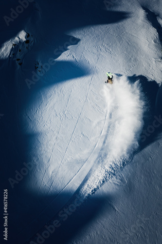 A woman is powder skiing in Gastein, Austria.