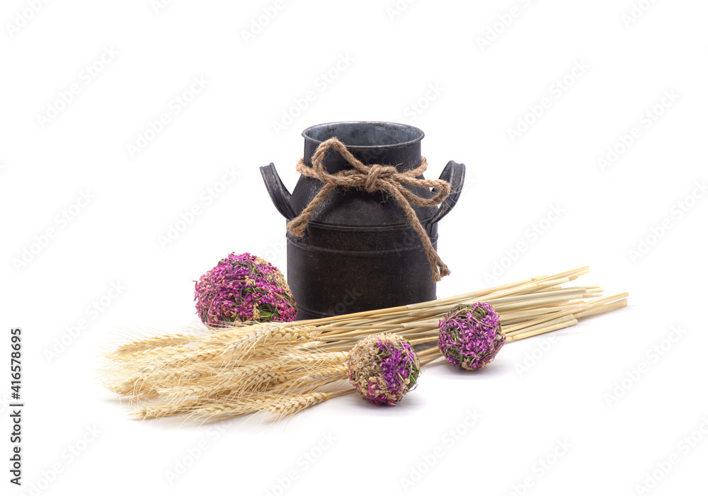Composition of wheat, antique jug, dried flowers on white background