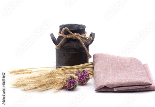 Composition of wheat, antique jug, kitchen towel and dried flowers on white background