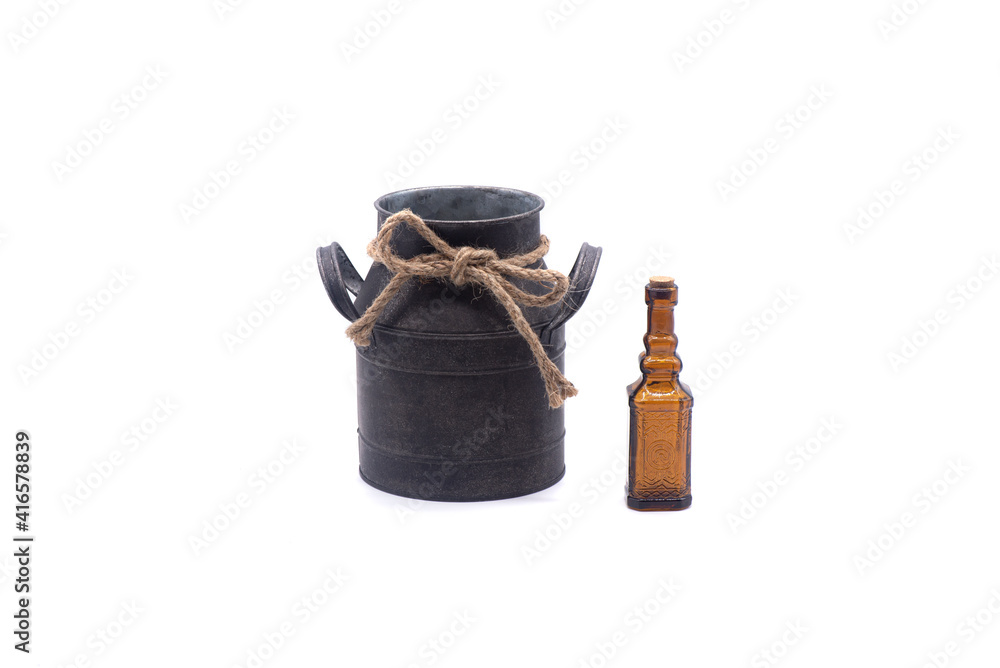 Small empty brown glass bottle and retro pot on white background
