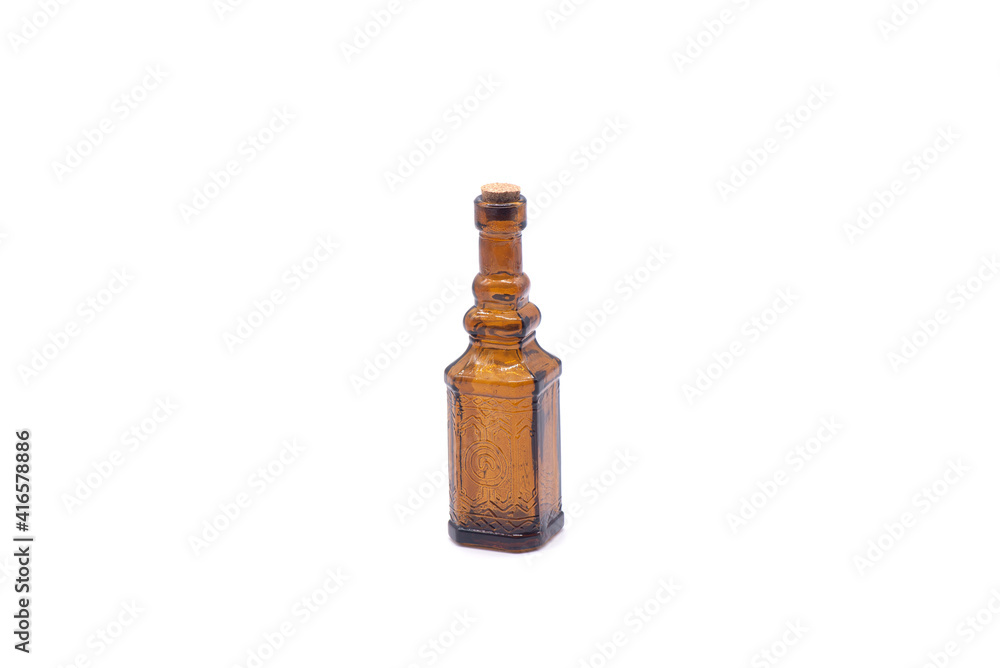 Small empty brown glass bottle on white background