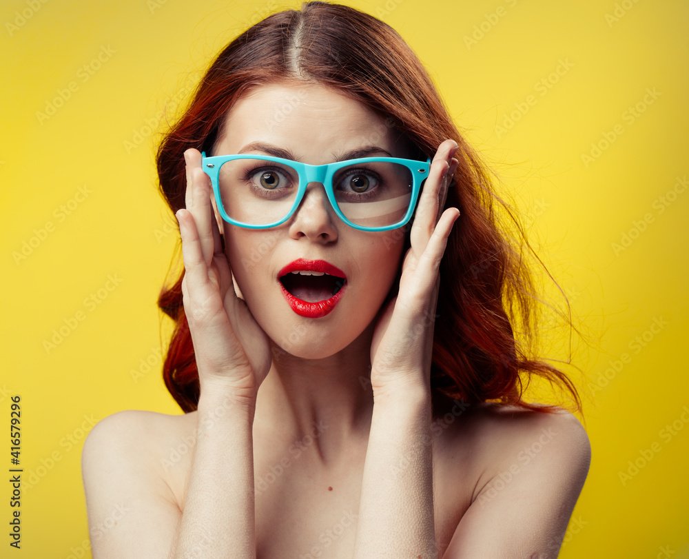 attractive woman with bare shoulders red lips blue glasses close-up attractive woman with bare shoulders red lips blue glasses close-up