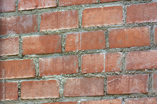 orange brick wall with cement