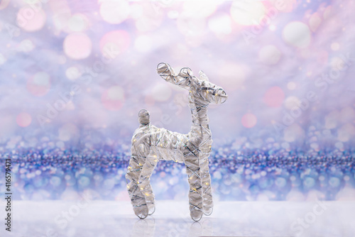 Glowing deer on a festive background. Christmas Concept