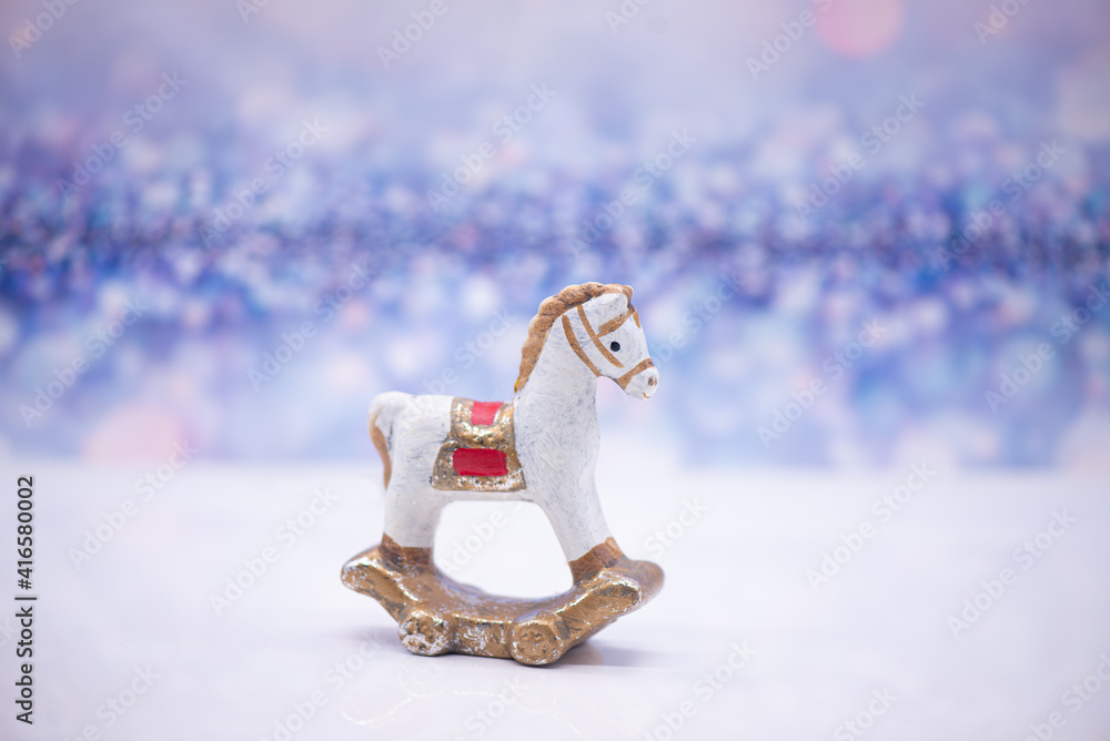 Toy clay horse on a festive background