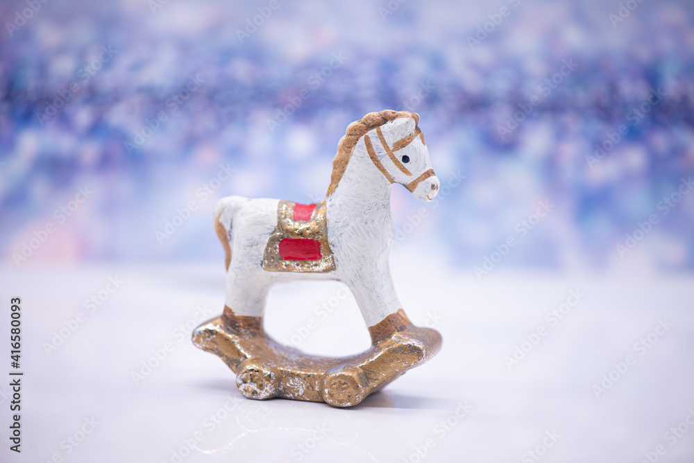 Toy clay horse on a festive background