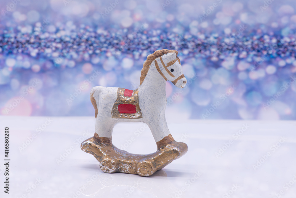 Toy clay horse on a festive background