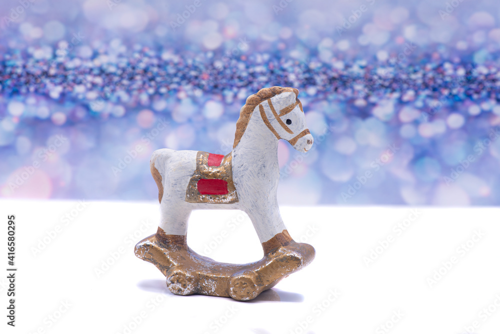 Toy clay horse on a festive background
