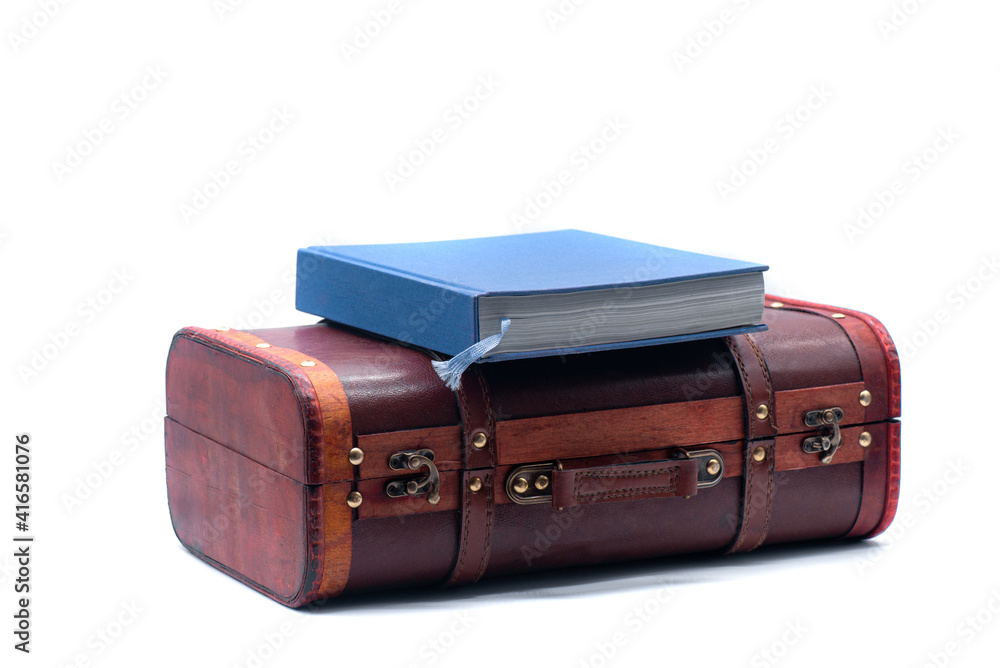 Retro suitcase and book on white background