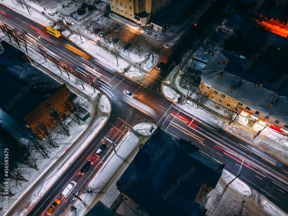 Night aerial view of crossroad with circular cars in small european city Night aerial view of crossroad with circular cars in small european city