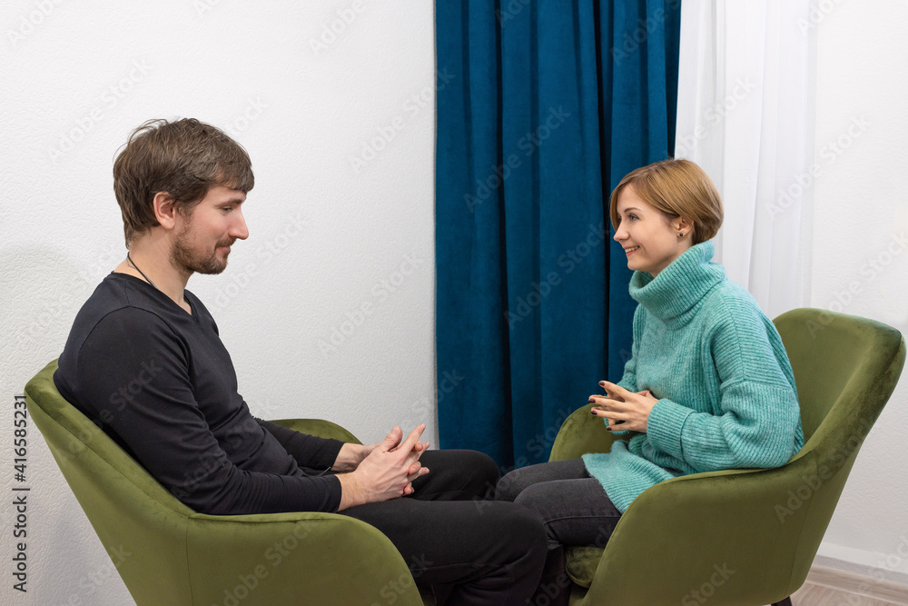 A young man is consulted by a psychologist in the office. A bearded man sits on the couch listening to a psychologist. Psychological counselor concept A young man is consulted by a psychologist in the office. A bearded man sits on the couch listening to a psychologist. Psychological counselor concept