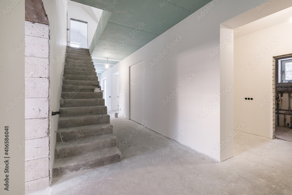 empty white room with concrete stair without repair and furniture empty white room with concrete stair without repair and furniture