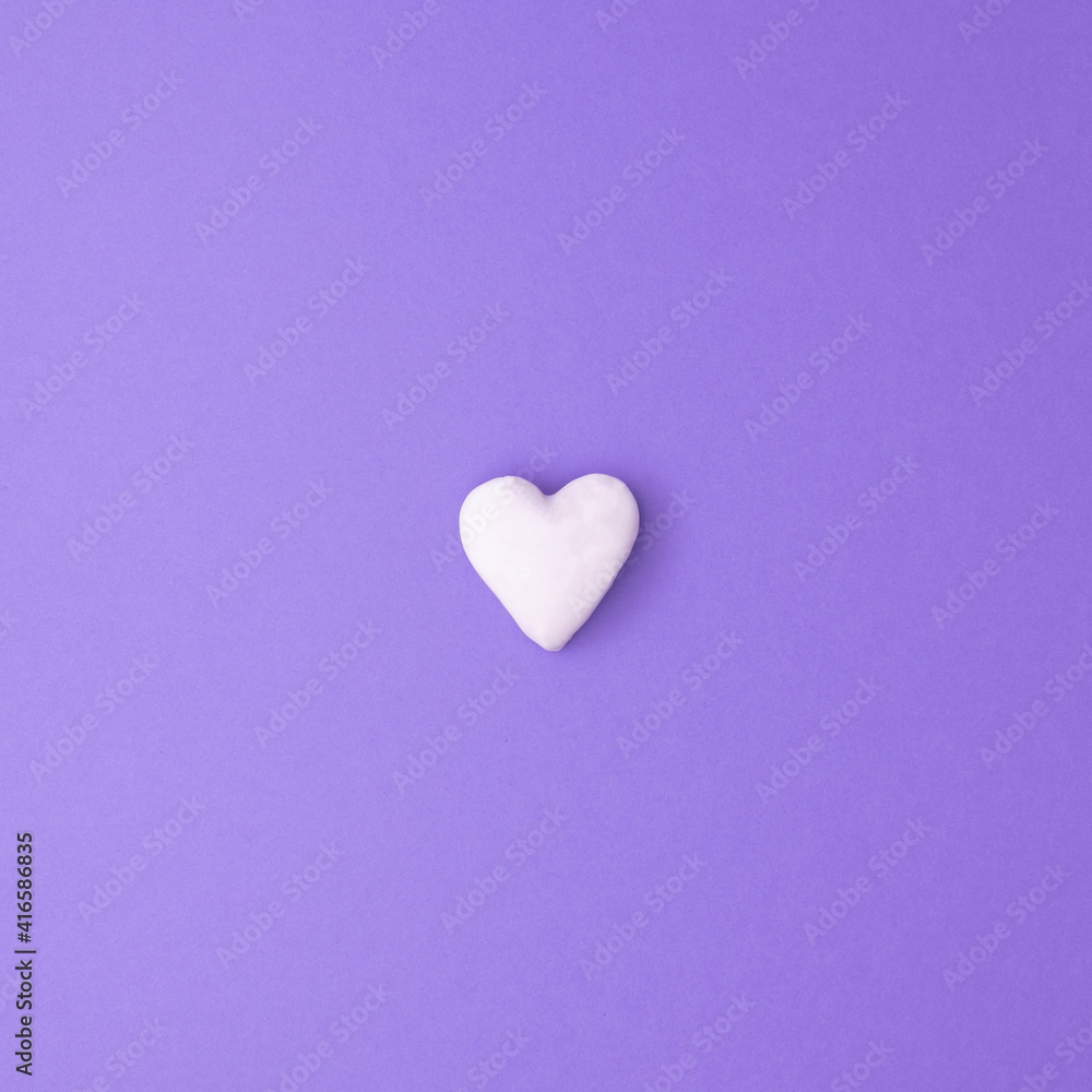 Square love concept idea with small white heart on purple background. Minimal flat lay.