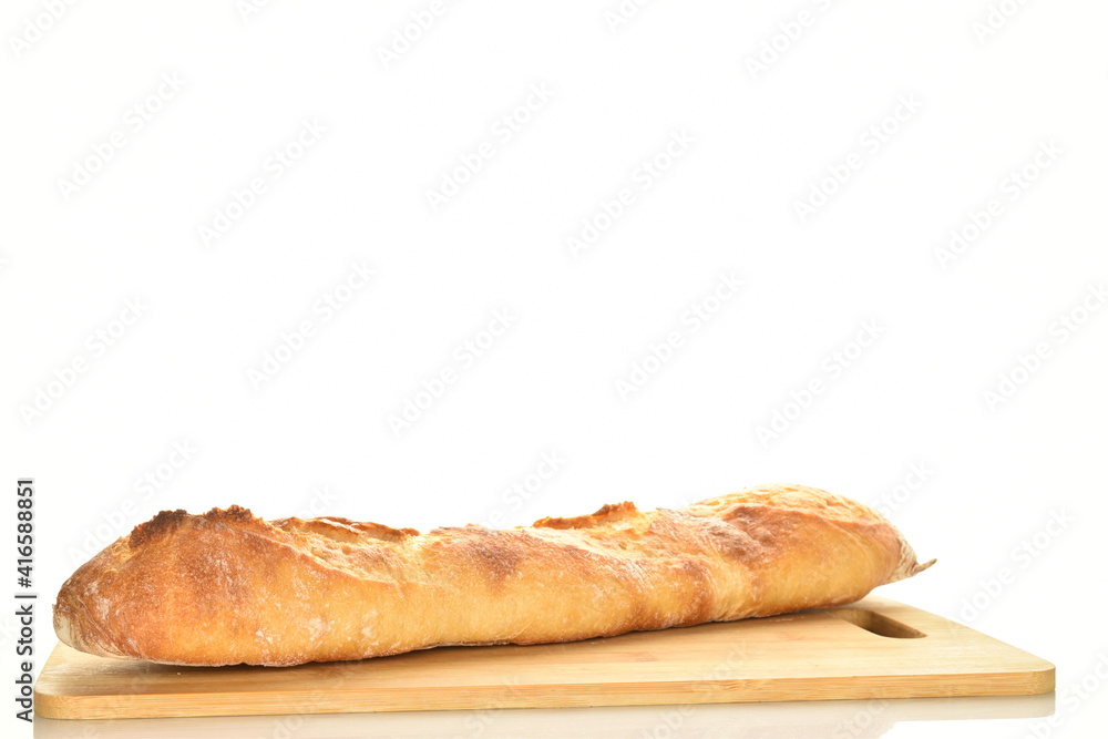 One freshly baked French baguette on a wooden board, close-up, isolated on white.