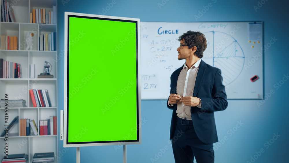 Portrait of Friendly Teacher Explains Lesson to a Classroom, Uses Green Screen Digital Whiteboard. Successful Businessman Talks about Project Growth Uses Chroma Key Digital Blackboard Portrait of Friendly Teacher Explains Lesson to a Classroom, Uses Green Screen Digital Whiteboard. Successful Businessman Talks about Project Growth Uses Chroma Key Digital Blackboard