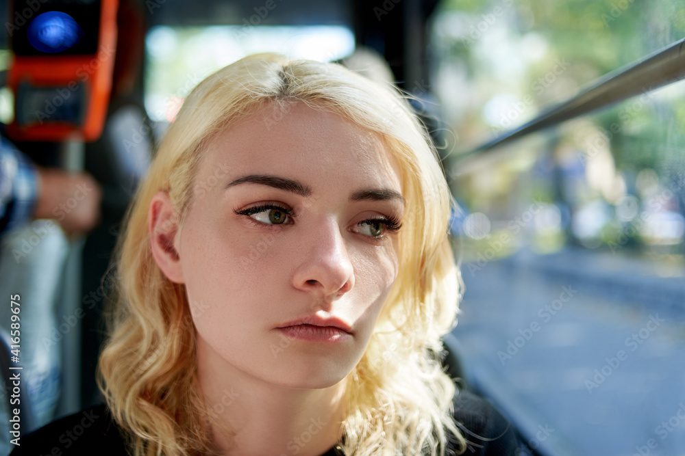 Portrait of a sad beautiful young woman who rides in a trolleybus. Portrait of a sad beautiful young woman who rides in a trolleybus.