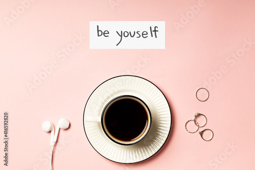 The inscription "Be yourself" on a pink background
