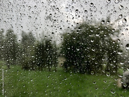 rainy drops on the window in summer time 