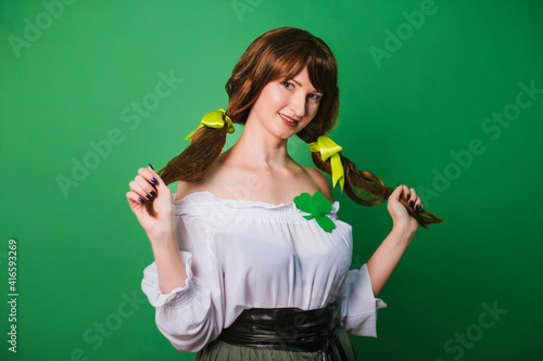The girl celebrates st patrick's day. A woman in a medieval historical costume.
