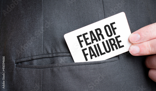 Card with Fear of Failure text in pocket of businessman suit. Investment and decisions business concept.
