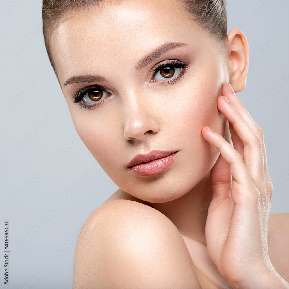 Closeup portrait of a face of the young pretty girl with a healthy skin. Beautiful face of young white woman with a clean skin. Skin care concept. Closeup portrait of a face of the young pretty girl with a healthy skin. Beautiful face of young white woman with a clean skin. Skin care concept.