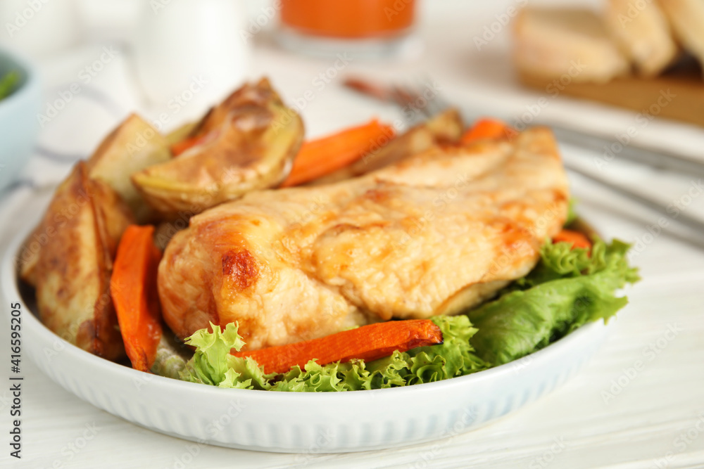 Delicious cooked chicken and vegetables on white table, closeup. Healthy meals from air fryer