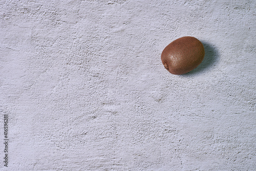 A kiwi fruit on a stone