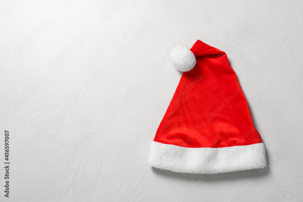 Santa Claus hat on light grey background, top view. Space for text Santa Claus hat on light grey background, top view. Space for text