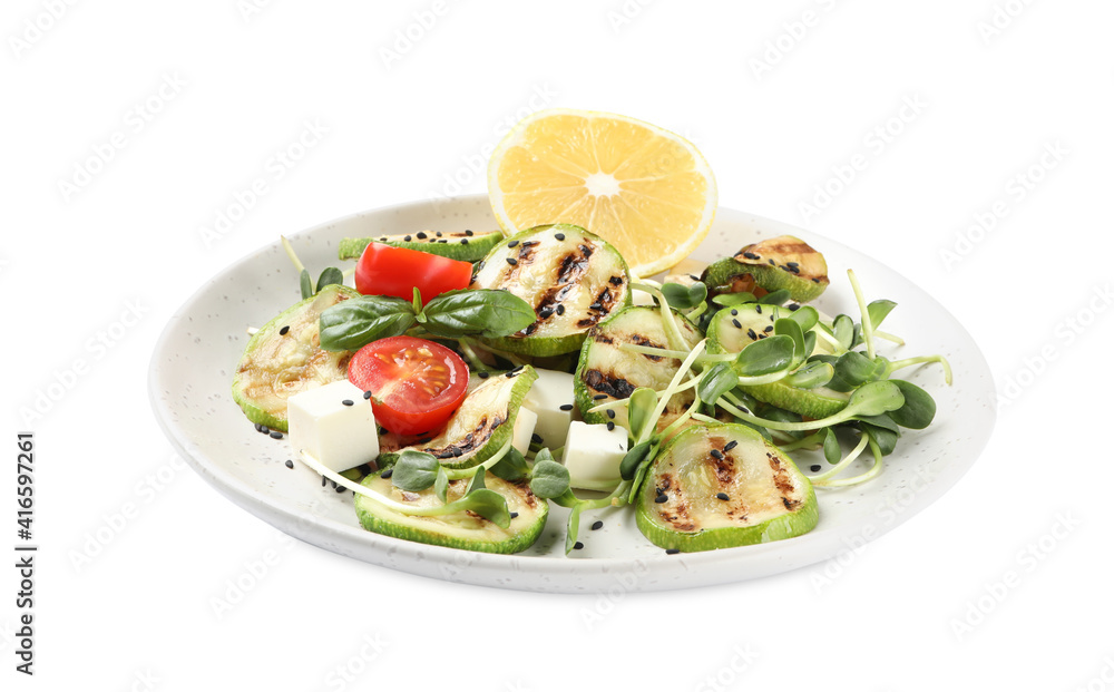 Delicious grilled zucchini slices served with feta cheese, tomatoes and lemon on white background Delicious grilled zucchini slices served with feta cheese, tomatoes and lemon on white background