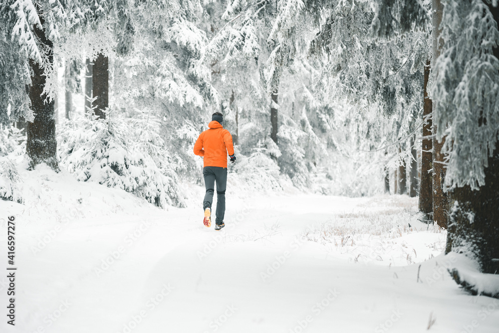 Jogging Läufer in orangener Jacke im Winter