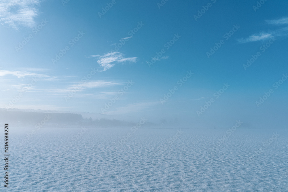Clouds and snow meets in fog at winter, Toten, Norway.