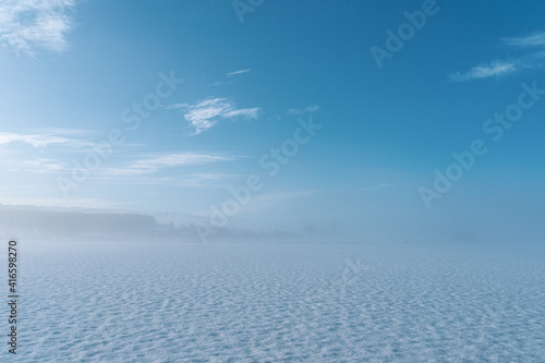 Clouds and snow meets in fog at winter, Toten, Norway.