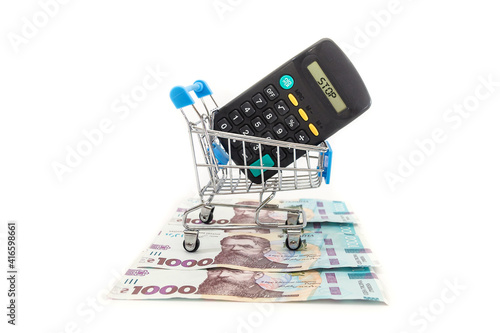 calculator in a shopping cart and 1000 hryvnia on a white