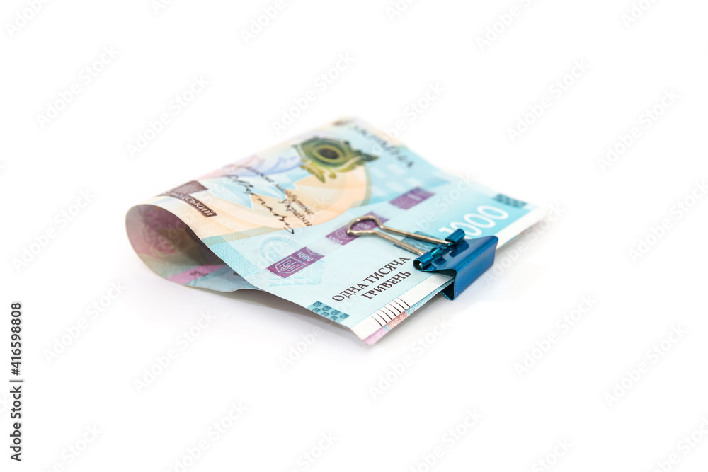 1000 hryvnia fastened with a clip on a white 1000 hryvnia fastened with a clip on a white