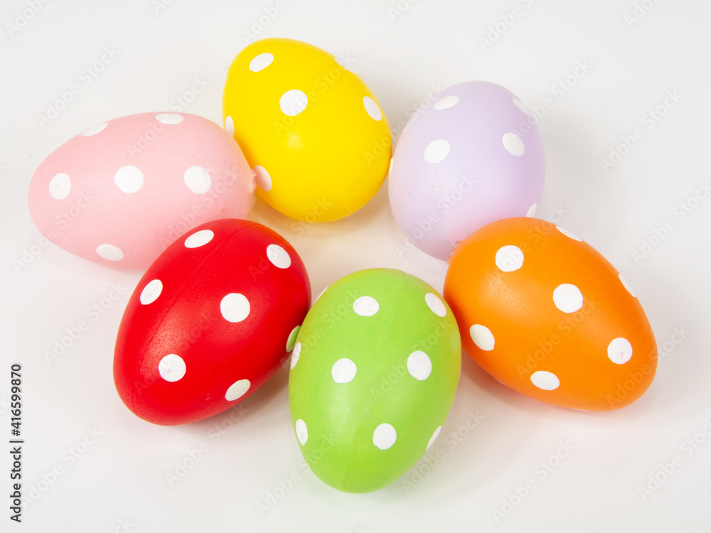 Multicolored easter eggs in dots on the white background