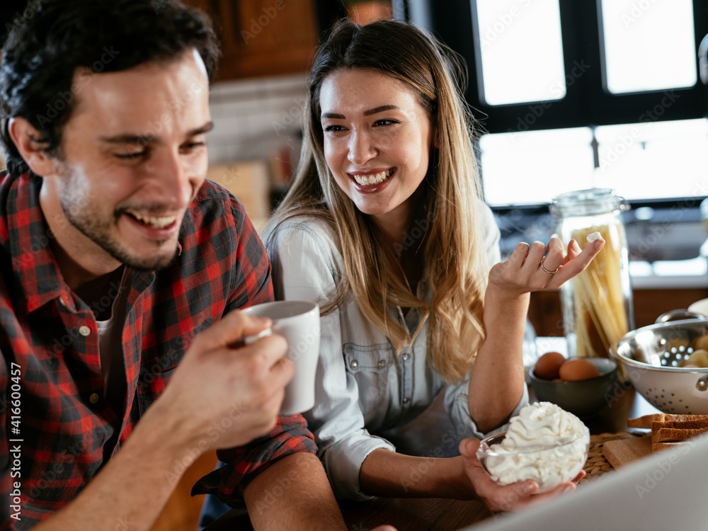 Loving couple drinking coffe in the kitchen. Happy smiling woman enjoy in the morning with her boyfriend. Loving couple drinking coffe in the kitchen. Happy smiling woman enjoy in the morning with her boyfriend.