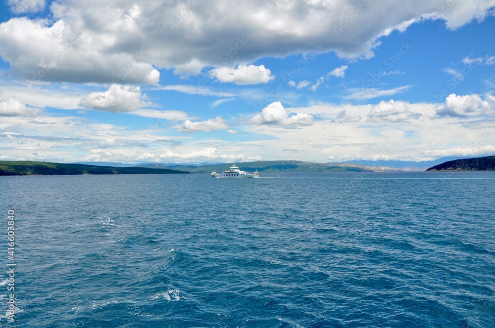 sland Cres, Croatia August 2020. Ferry boat floating in Adriatic Sea in Kvarner bay. sland Cres, Croatia August 2020. Ferry boat floating in Adriatic Sea in Kvarner bay.