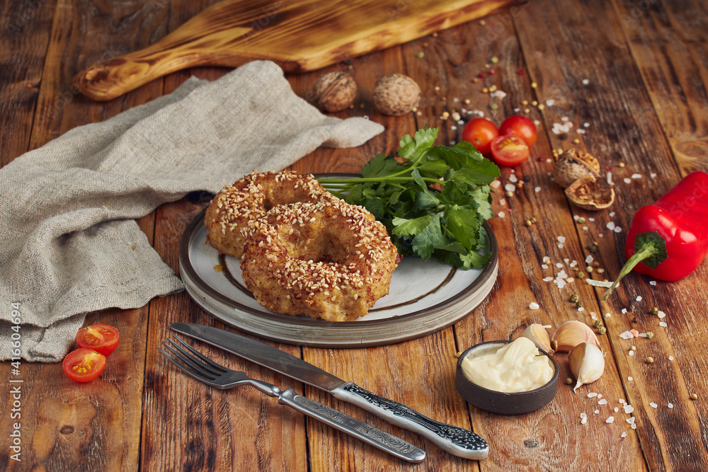 Fototapeta premium Fried minced meat (meat cutlet) on a plate, wooden background