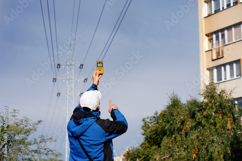 Electromagnetic radiation measuring under high voltage power transmission towers among buildings